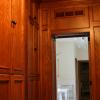 This Walk-In closet made from Red Oak and Natural Maple interiors features matching paneled walls, drawer base cabinets, roll out hampers, plenty of clothes hanging space, adjustable shelving and shoe cubbies.Also, a full length mirror, open glass shelf cabinet & pull out folding area. 